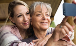 Züm Closer Than You Know campaign image shows adult daughter taking selfie with her mom.