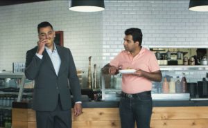Random Banker steals a samosa from stunned South Asian diner and takes a massive bite.