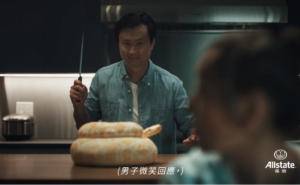 Chinese man with knife about to attack a cake in the shape of a snake